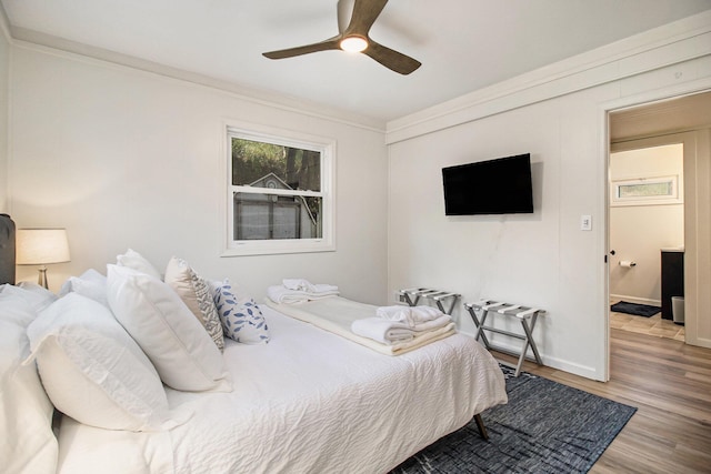 bedroom featuring ornamental molding, ceiling fan, and light wood-type flooring