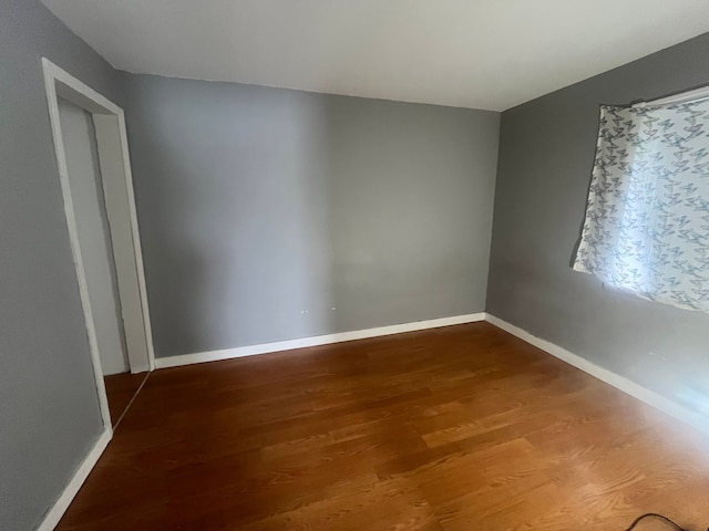 unfurnished room with wood-type flooring