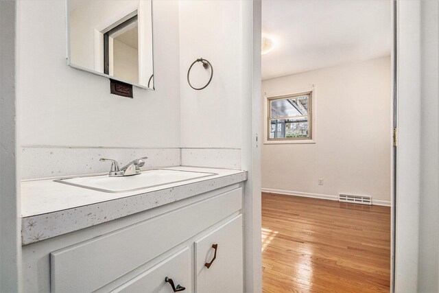 bathroom with vanity and hardwood / wood-style floors