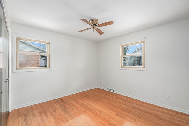 empty room featuring ceiling fan and light wood-type flooring