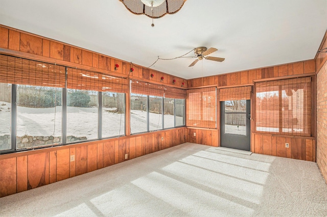 sunroom / solarium featuring a wealth of natural light and ceiling fan