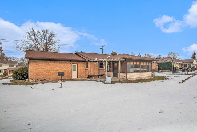 back of house with a pergola and a sunroom