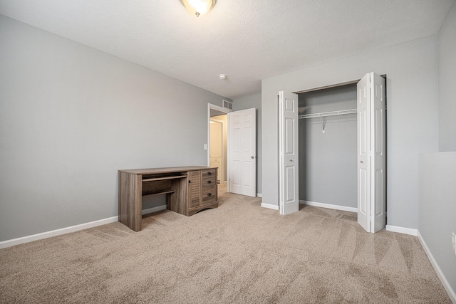 carpeted bedroom featuring a closet and a textured ceiling