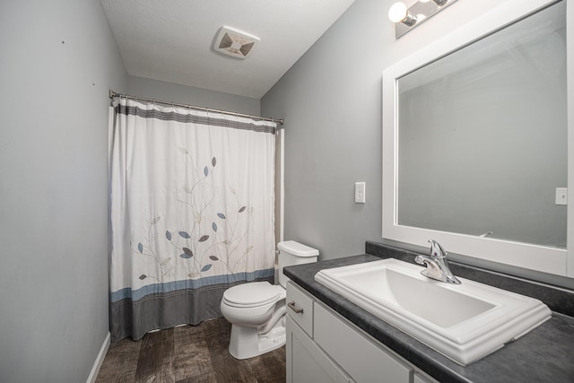 bathroom with vanity, hardwood / wood-style floors, a shower with shower curtain, and toilet