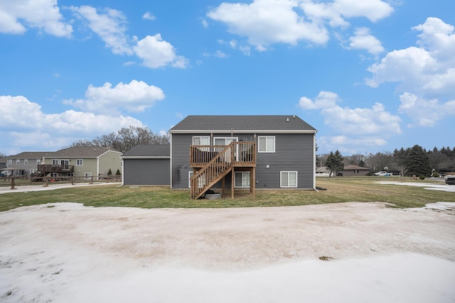 rear view of house featuring a yard and a deck