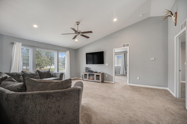 living room with ceiling fan, plenty of natural light, high vaulted ceiling, and carpet floors