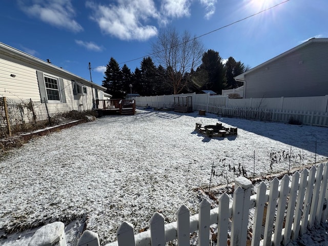 snowy yard featuring a wooden deck