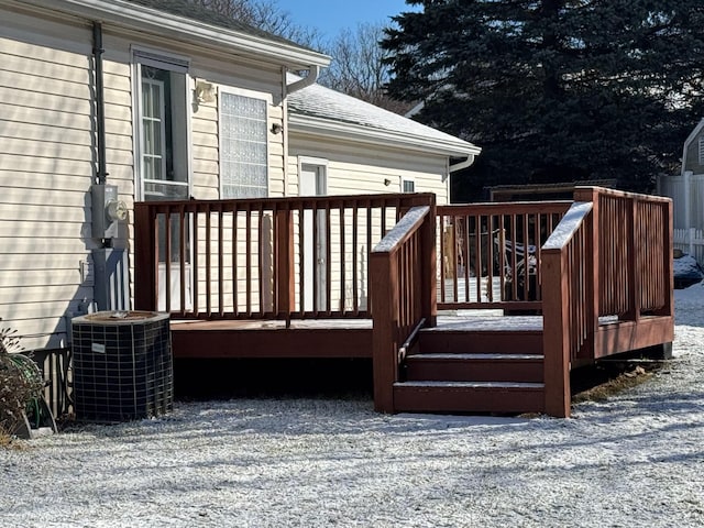 snow covered deck featuring cooling unit