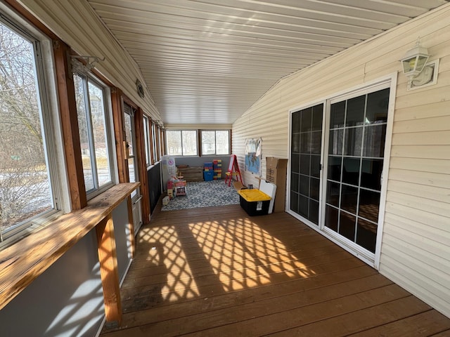 unfurnished sunroom with vaulted ceiling