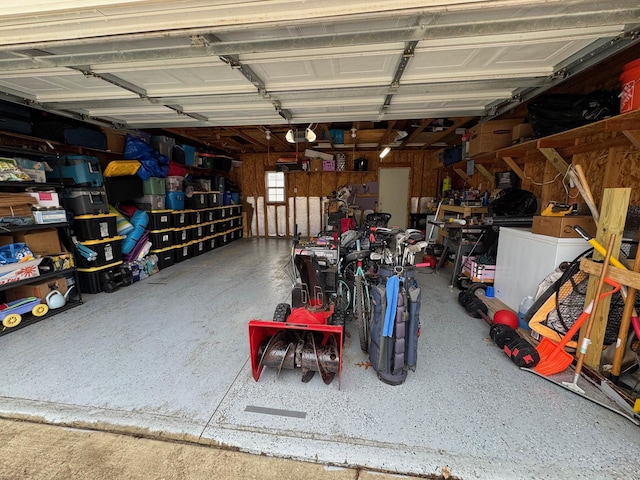 garage with a garage door opener and separate washer and dryer