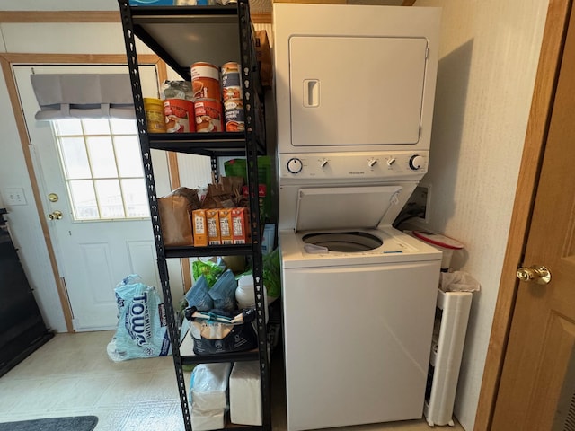 laundry room featuring stacked washer / drying machine