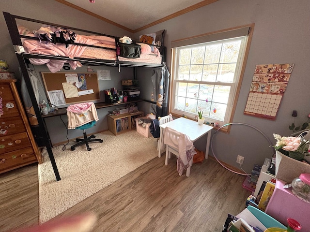 office space featuring ornamental molding, vaulted ceiling, and wood-type flooring