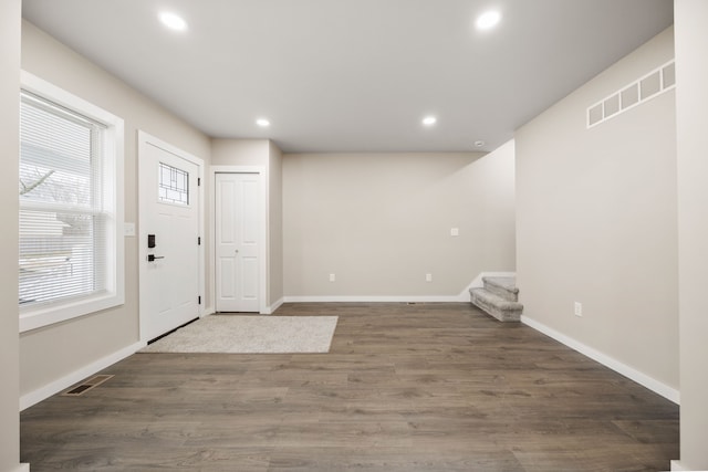 entryway with dark hardwood / wood-style flooring