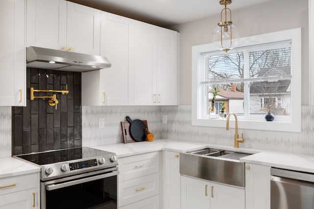 kitchen featuring white cabinetry, sink, decorative backsplash, and stainless steel appliances