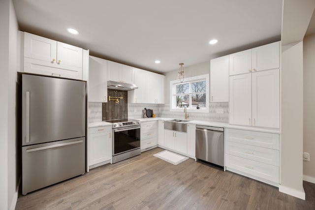 kitchen with white cabinetry, stainless steel appliances, light hardwood / wood-style floors, and sink