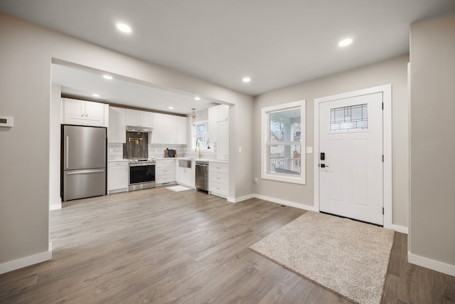 entryway featuring sink and light hardwood / wood-style flooring