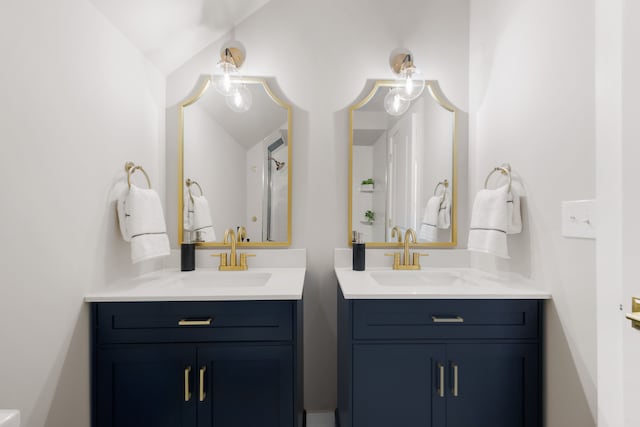 bathroom featuring vanity and lofted ceiling