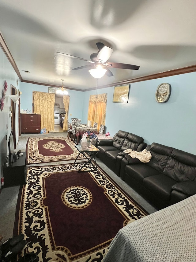 living room featuring ornamental molding, ceiling fan, and carpet flooring