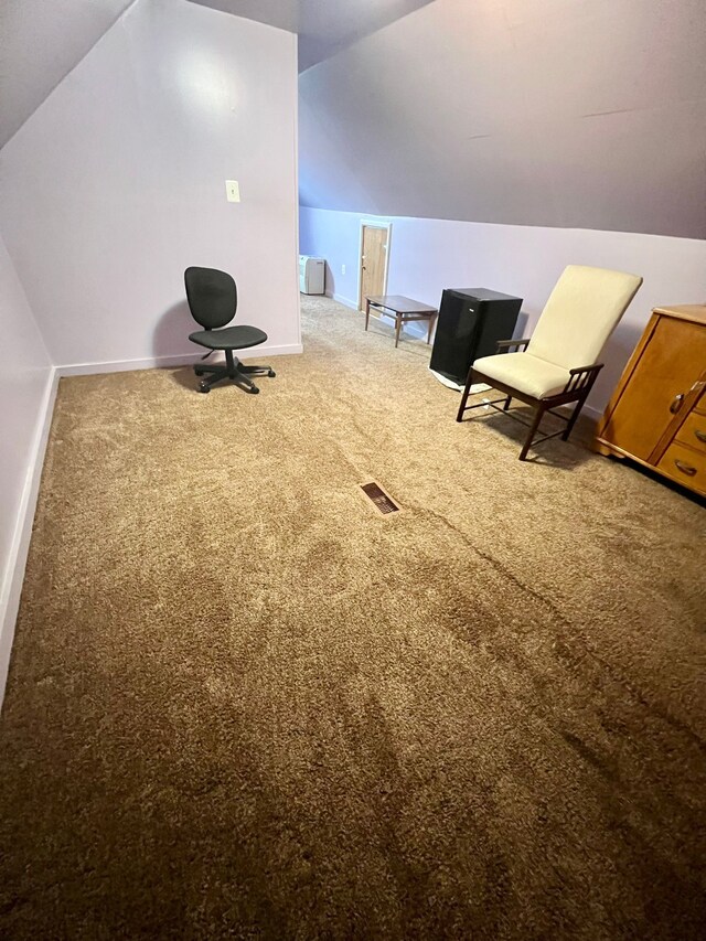 unfurnished room featuring vaulted ceiling and carpet