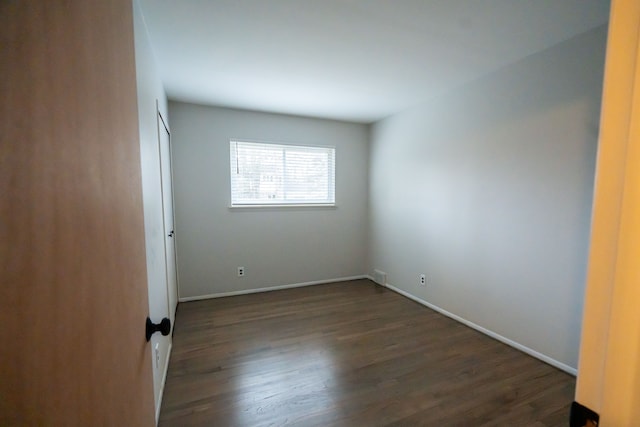 spare room with dark hardwood / wood-style flooring