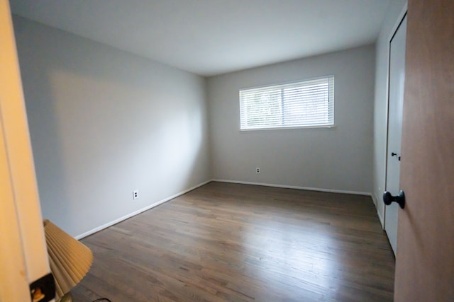 spare room featuring dark hardwood / wood-style floors