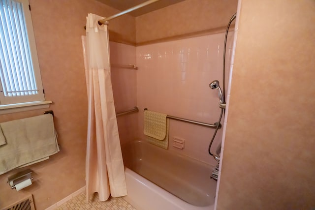 bathroom featuring tile patterned floors and shower / tub combo