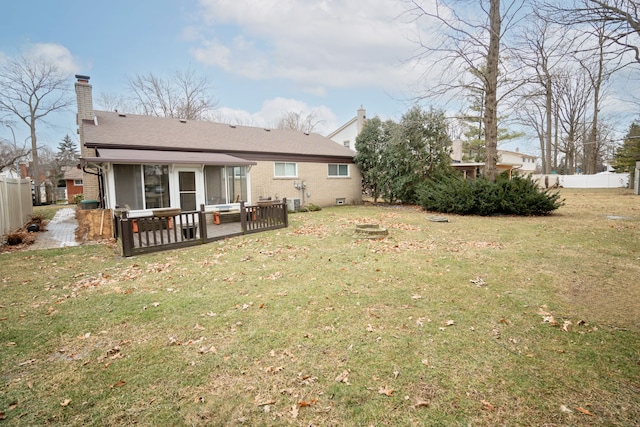 rear view of property featuring a lawn