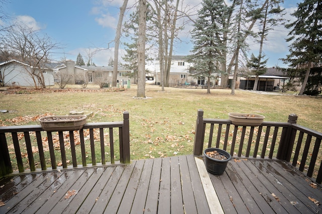 wooden terrace featuring a yard