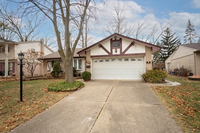 view of front of house with a garage and a front lawn