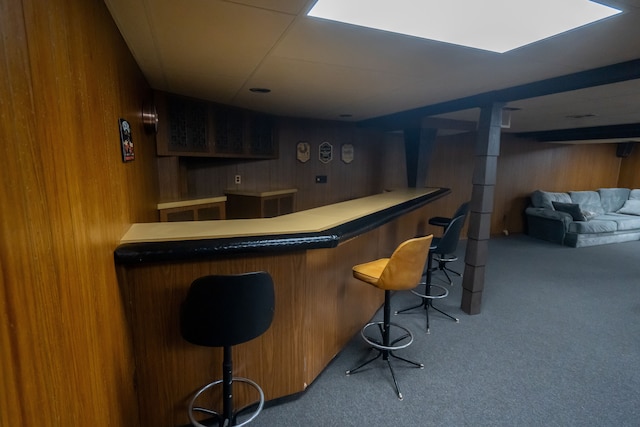 bar with carpet floors and wood walls