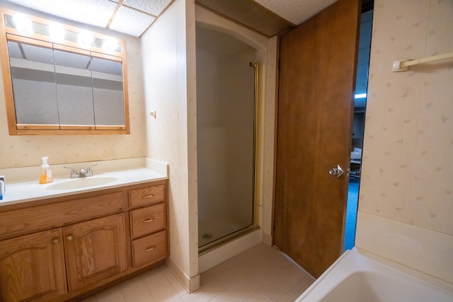 bathroom with tile patterned flooring, shower with separate bathtub, and vanity