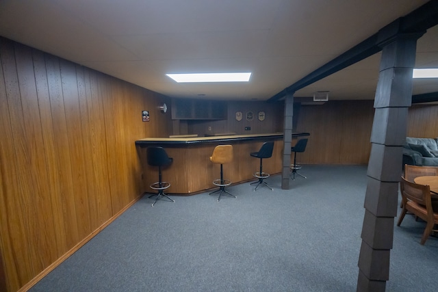 bar featuring wooden walls and light colored carpet