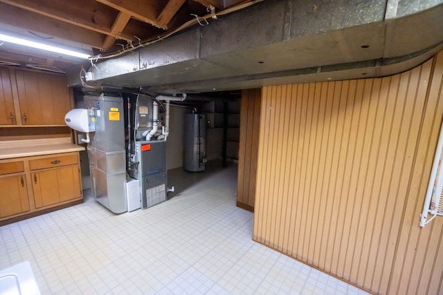 basement featuring heating unit and water heater