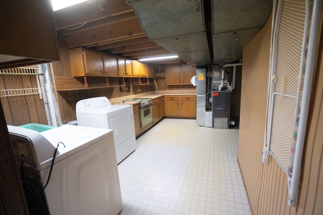 laundry area with independent washer and dryer and heating unit