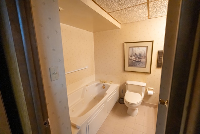 bathroom with toilet, tile patterned floors, and a tub to relax in