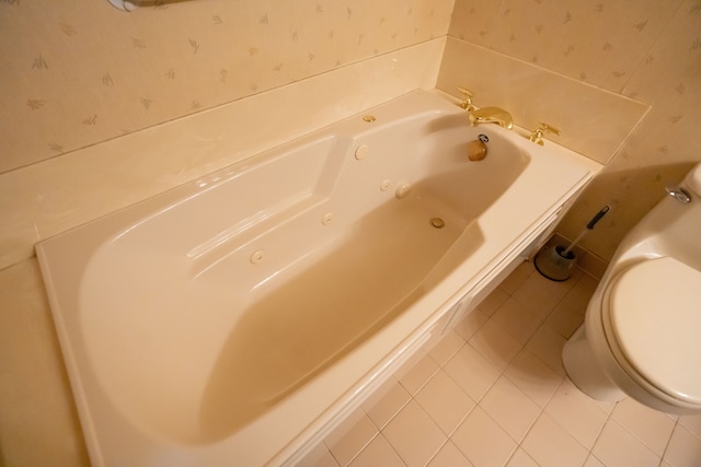 bathroom featuring tile patterned floors, toilet, and a bathtub