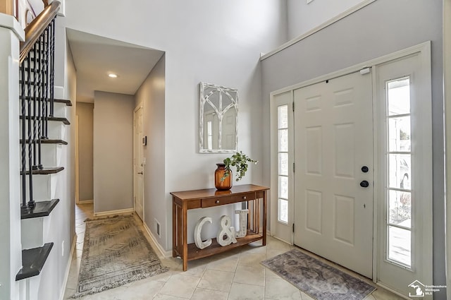 tiled foyer with a wealth of natural light