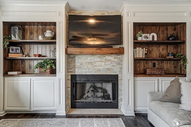 living room featuring built in shelves and dark wood-type flooring