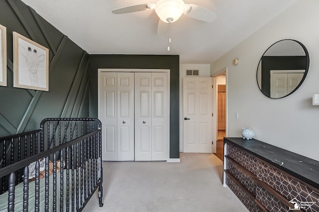 carpeted bedroom with a closet and ceiling fan