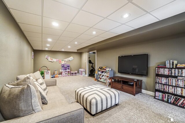 living room featuring carpet floors and a paneled ceiling