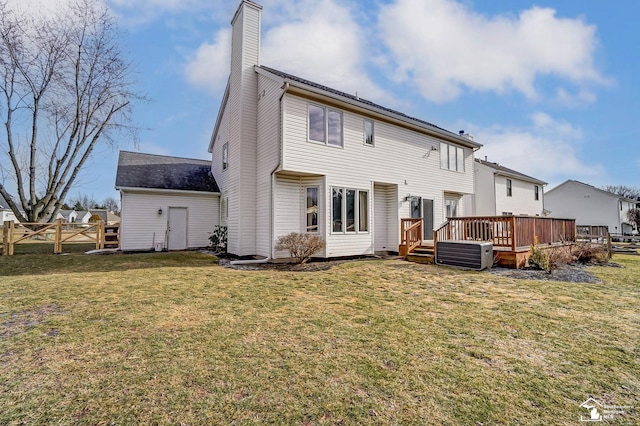 back of house with a wooden deck and a yard