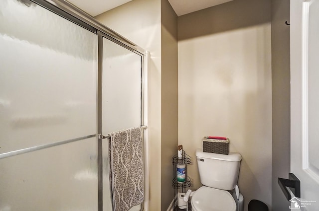 bathroom featuring toilet and walk in shower