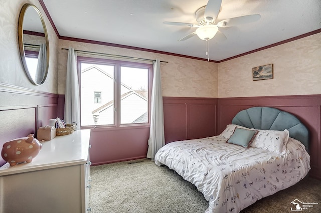 carpeted bedroom featuring ceiling fan and ornamental molding