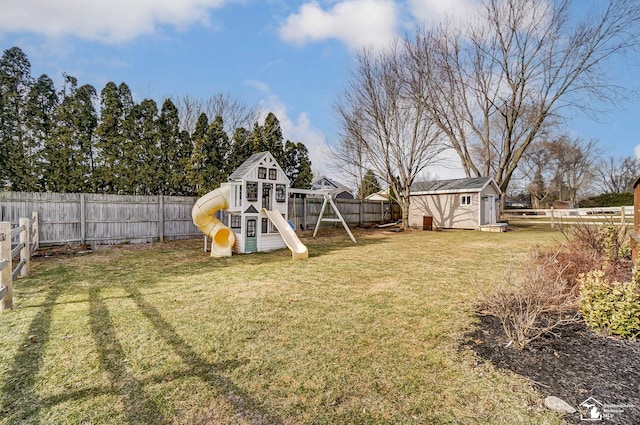 view of yard with a storage unit and a playground