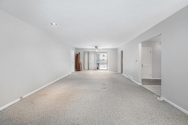 carpeted empty room with ceiling fan and a textured ceiling