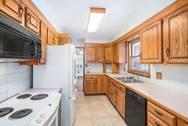 kitchen featuring light tile patterned flooring, sink, tasteful backsplash, and black appliances