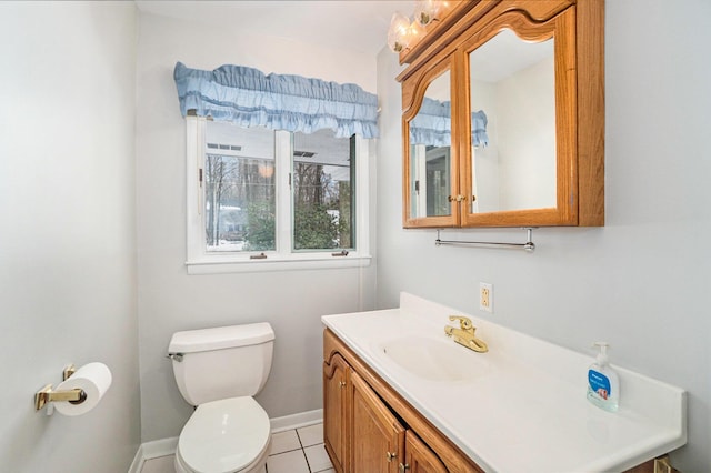 bathroom featuring vanity, toilet, and tile patterned flooring