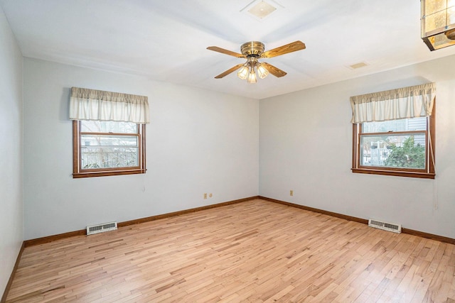 empty room with ceiling fan and light wood-type flooring