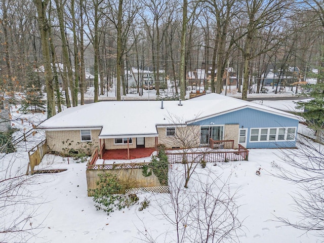 view of snow covered back of property