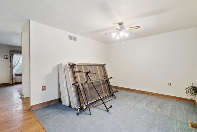 living area featuring hardwood / wood-style flooring and ceiling fan